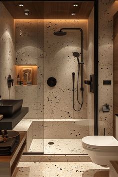 a bathroom with a walk in shower next to a toilet