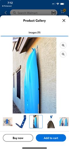 a blue surfboard sitting on the side of a building