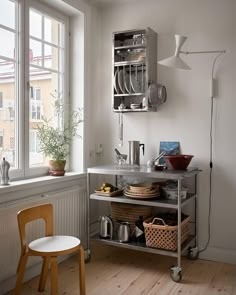 a kitchen with a window and shelves filled with dishes