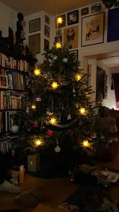 a small christmas tree is lit up in the living room