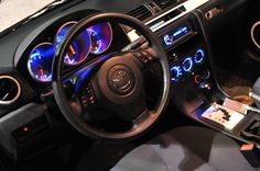 the interior of a car with various gauges and dash lights