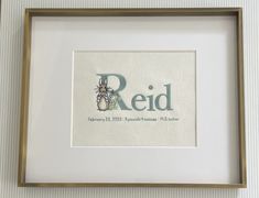 a framed cross stitch art piece with the word red on it