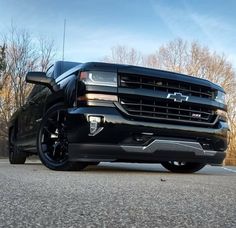 the front end of a black chevy truck