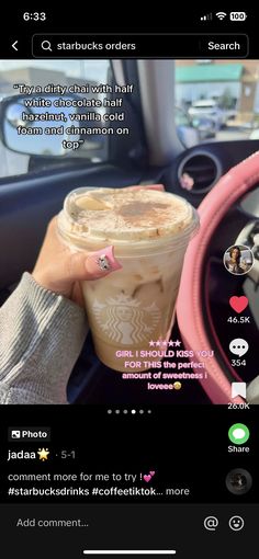 someone holding up a cup of coffee in their car