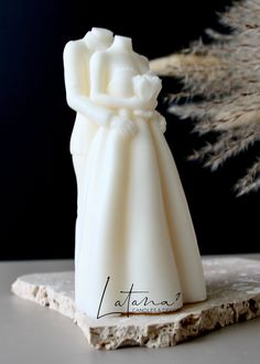 a white wedding cake topper on a table