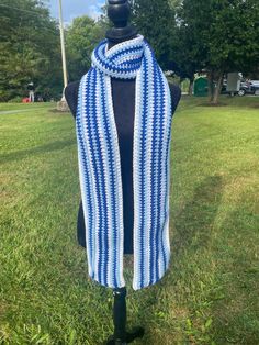 a blue and white striped scarf on top of a mannequin