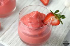 two small glasses filled with ice cream and strawberries