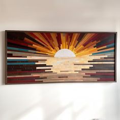 a painting hanging on the wall above a bed