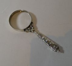 a silver keychain that is sitting on a table