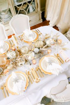 the table is set with gold and white dishes