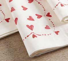 two napkins with red hearts on them