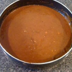 a metal pan filled with sauce on top of a counter