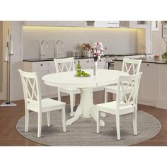 a white kitchen table with four chairs around it