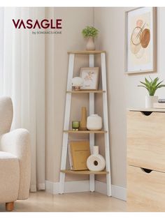 a white shelf with books and other items on it in front of a beige chair