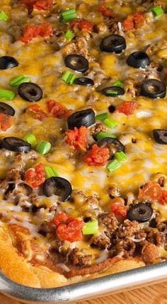 a pizza with cheese, olives and ground beef