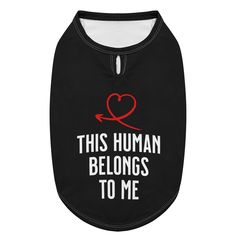 a black dog shirt that says, this human belongs to me