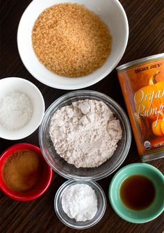 ingredients to make pumpkin muffins laid out on a wooden table next to each other