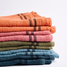 a stack of folded towels sitting on top of each other