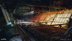 an abandoned factory with graffiti on the wall and metal pipes running down it's sides