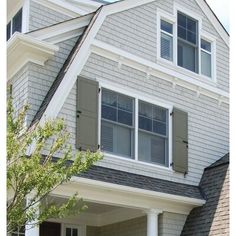 a house with white trim and gray shutters