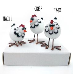 three small white chickens standing on top of a box with words above them that read criss and two