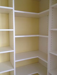 an empty white shelving unit in a room with no one on the shelf or floor