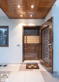 an entry way with a wooden door and tiled floor