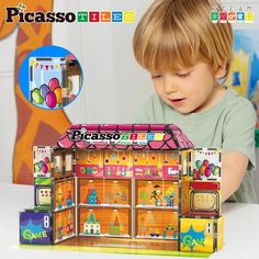 a young boy playing with a toy house