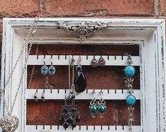 an old window with jewelry hanging on it