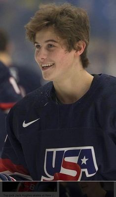 a young man is smiling while playing ice hockey