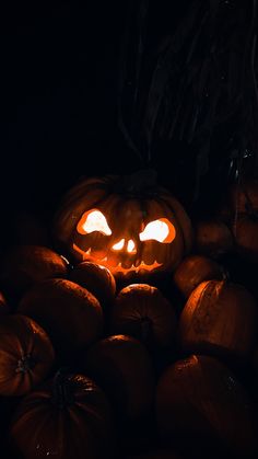 a pumpkin with glowing eyes in the dark