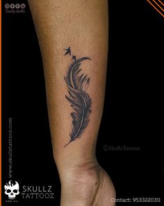 a black feather tattoo on the leg