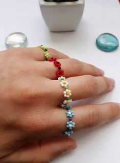 Beautiful,Colorful,Cute,Stackable Rings Make your day more colorful with some of my items. Each one of them is handmade with a lot of love and positive energy. Handmade rings with flowers, where you can choose the color of the flower, the stamen and the band. Depending on where you are viewing the item on a mobile device or monitor, colors may have a slight discrepancy. If you have questions or ideas, do not hesitate to ask them. Thank you for visiting my store! For more great jewelry you can visit this link  https://www.etsy.com/shop/NataliaArttCo?ref=seller-platform-mcnav Rings With Flowers, Rings Beaded, Beaded Diy, Surf Bracelet, Kabbalah Bracelet, 4 Friends, Beads Ring, Flower Rings, Crafts Videos