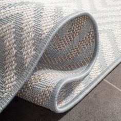 a rug is laying on the floor with it's end rolled up