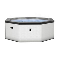 an outdoor hot tub with blue water in the center and black trimmings on the sides