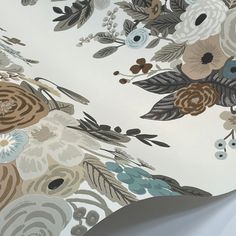 an up close shot of a flowered wallpaper with blue, brown and white flowers