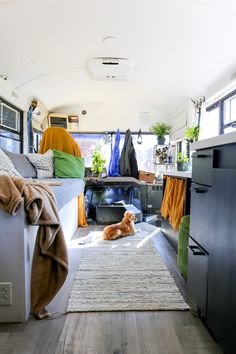 the interior of a camper with a dog laying on the floor next to it