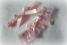 Listing includes a white or ivory lace garter with light pink satin bridal garter which includes yours to keep and one to toss.  Accented with a rhinestone accent on the keep garter.  Shown is a clear rhinestone but light pink rhinestone is available. More ribbon colors available.  Please contact me Ribbon colors can be changed https://www.etsy.com/listing/663061736/ribbon-colors-this-is-for-viewing-ribbon Garters are made to measure. Don't need both garters?  Please contact me.Garters are made Pink Garter, Lace Garter Set, Ivory Flower Girl, Pink Crown, Custom Ribbon, Lace Garter, Bridal Garter, Garter Set, Flower Girl Basket