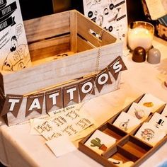 a table topped with wooden boxes filled with cards