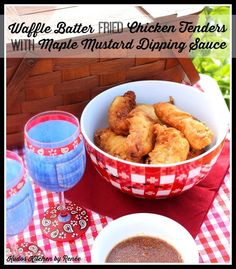 a bowl of fried chicken tenders with maple mustard dipping sauce next to two glasses