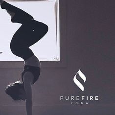 a woman doing yoga in front of a window with the words purefire yoga on it