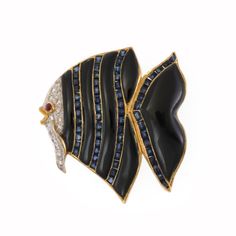 Onyx Sapphire Ruby & Diamond 18k Two Tone Gold Fish Brooch Onyx Sapphire Ruby & Diamond 18k Two Tone Gold Fish Brooch Description   This is a charming brooch, crafted from 18k yellow gold with white gold accent featuring a fish decorated with alternating black onyx and square shape channel set sapphire. The head of the fish is in white gold with yellow gold accent, around the white gold are pave set diamonds, the eye of the fish is a small cabochon ruby. The pin has a safety clasp. Material:  18k yellow and white gold Main stone:  sapphire and onyx Secondary stone:  diamond and a single ruby Measurements:  30mm long x 31mm wide x 5mm high Weight:  8.6 grams Stock#  67477     Click images to enlarge Payment   We accept payments through Paypal. We only ship to PayPal confirmed billing addres Cabochon Ruby, Fish Brooch, Gold Fish, Ruby Diamond, Channel Set, Gold Accent, The Fish, Goldfish, Square Shape