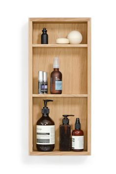 three wooden shelves with different types of skin care products on them and soaps in bottles