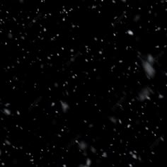 snow flakes are falling down on the black background with white dots in the foreground