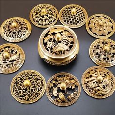 there are many decorative gold buttons on the black surface, including one with flowers and birds