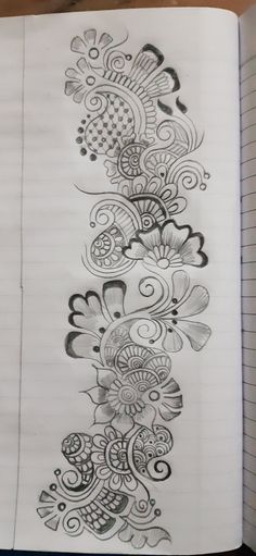 an open notebook with a drawing on it and some lines in the middle that look like flowers