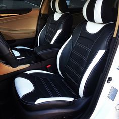 the interior of a car with black and white seats