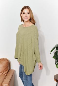 This top offers a harmonious blend of comfort and modern flair. Crafted from ultra-soft ribbed fabric, this top envelops you in luxurious coziness while maintaining a sleek aesthetic. The oversized fit exudes relaxed elegance, creating a versatile piece perfect for layering or wearing on its own. The unique sharkbite hem adds a dynamic touch to the design, allowing for a graceful drape and a hint of asymmetry. With its understated detailing and plush texture, this top becomes an essential additi Cozy Green Relaxed Fit Top, Versatile Oversized Green Top, Oversized Green Color Block Top, Asymmetrical Green Stretch Top, Oversized Green Soft-washed Tops, Relaxed Elegance, Sleek Aesthetic, Rib Knit Top, Layered Tops