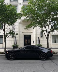 a black car parked in front of a building