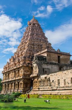 people are walking around in front of an ancient building that looks like it has been built into the ground